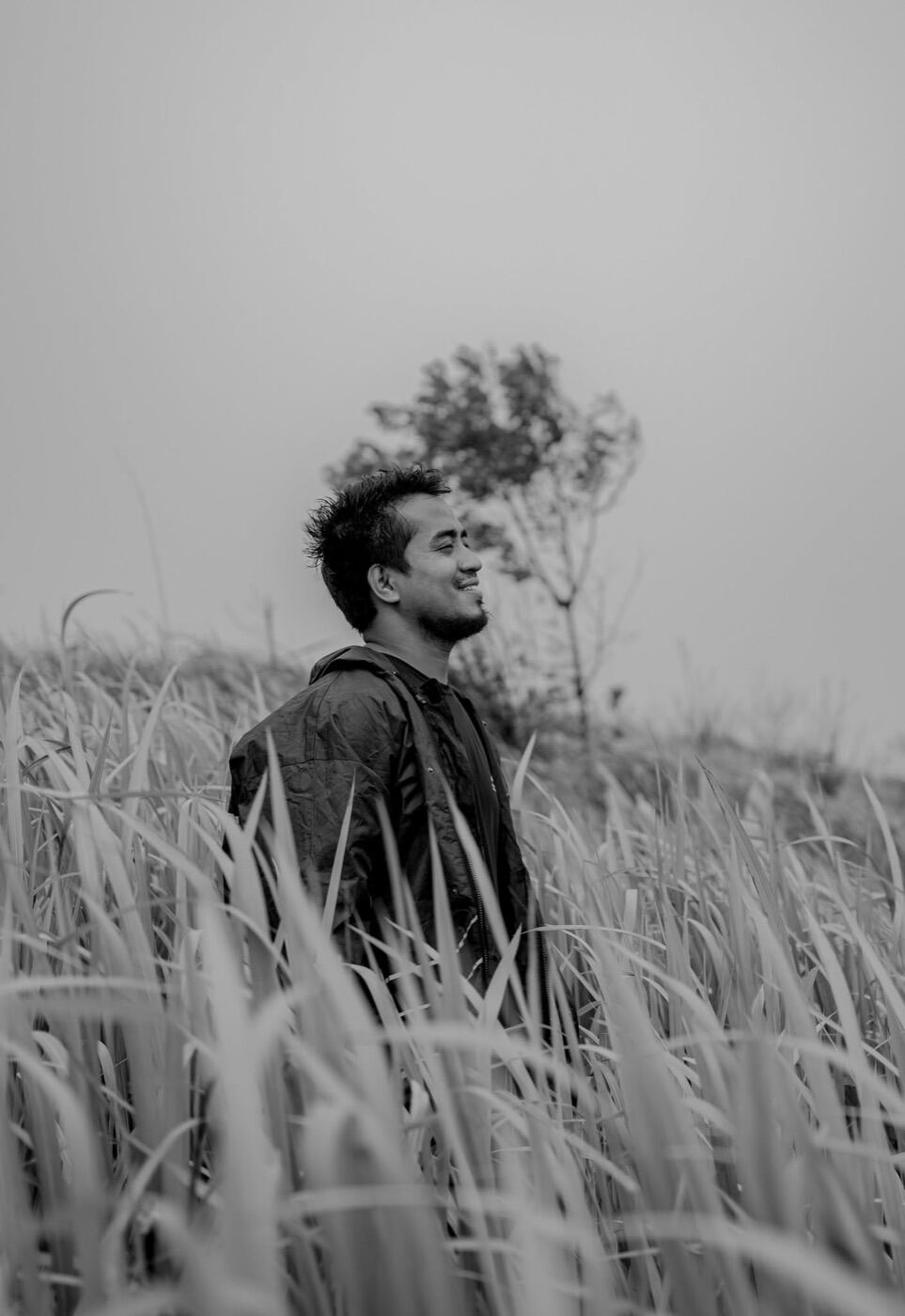 DharmaChandra Tonchongya in black and white among tall grass